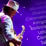 Carols Santana on guitar with song lyrics